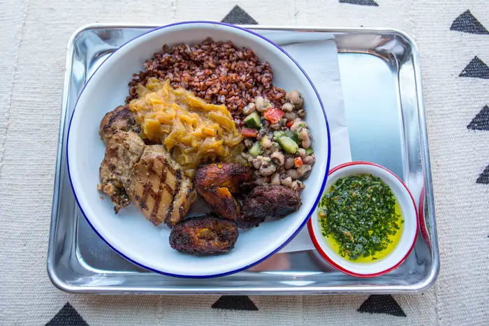 Grilled Chicken with Yassa, Liberian Ruby Red Rice, Kelewele, and Black-Eyed Peas Salad ($12)<br/>
